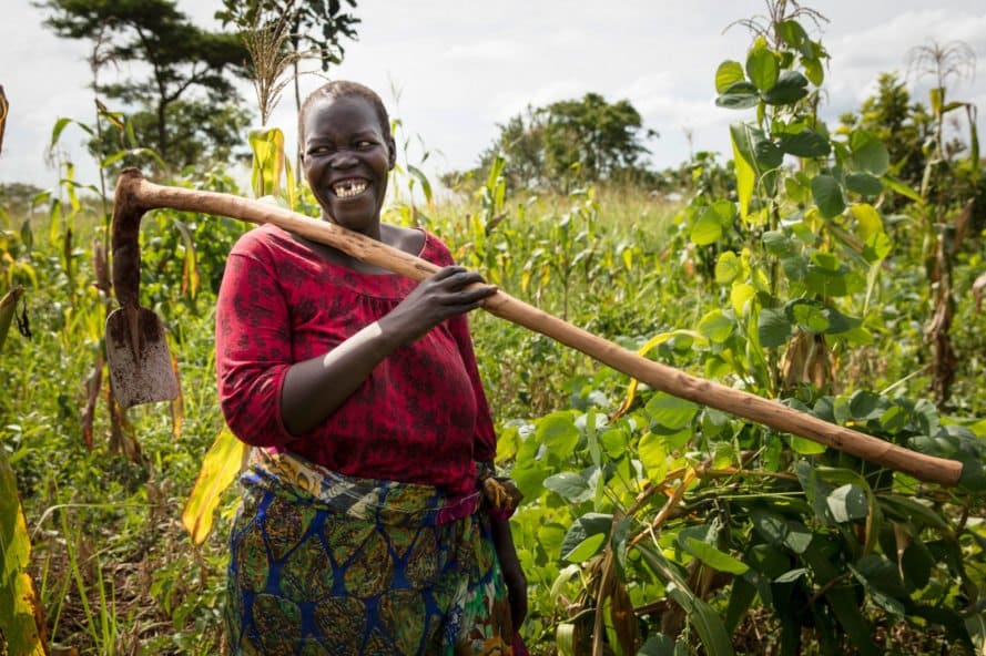 woman holding garden tool and smiling