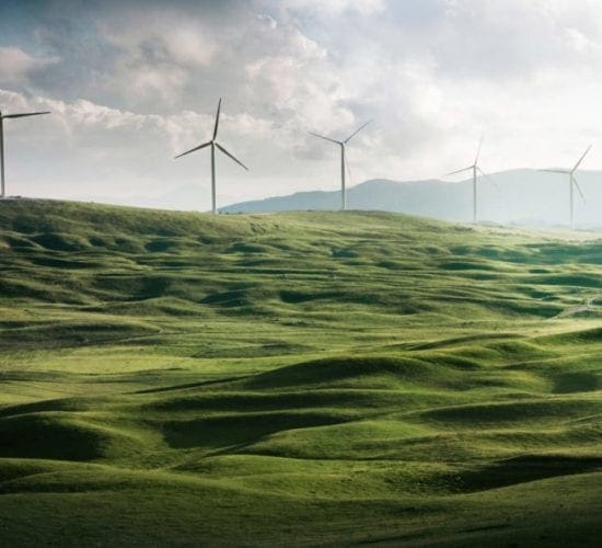 windmills on rolling green hills