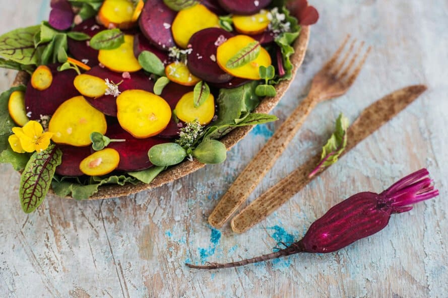 brown biodegradable tableware with colorful salad on plate