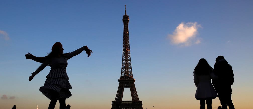 People stand at the Trocadero square near the Eiffel Tower in Paris, France, December 12, 2018. REUTERS/Gonzalo Fuentes - RC1641CE0740