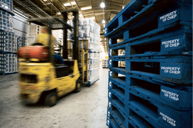 forklift lifting pallets in warehouse